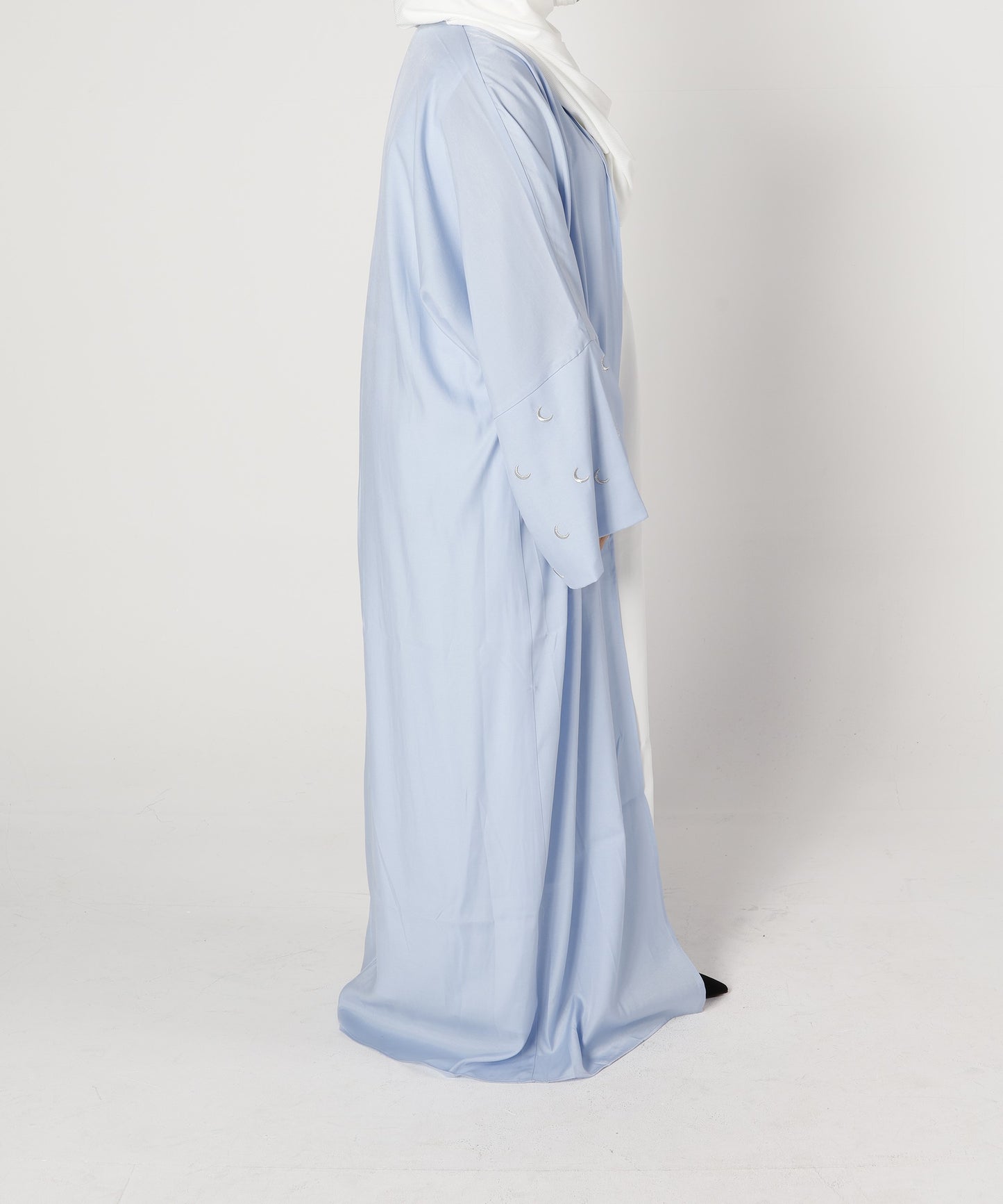 Side profile of Crescent abaya in blue pearl with moon embroidered sleeve detail – Qalbi