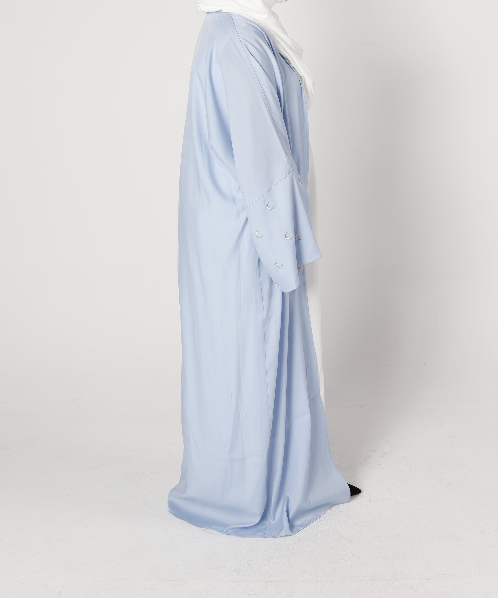Side profile of Crescent abaya in blue pearl with moon embroidered sleeve detail – Qalbi