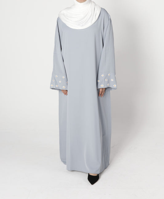 Front view of a grey abaya with floral embroidery.