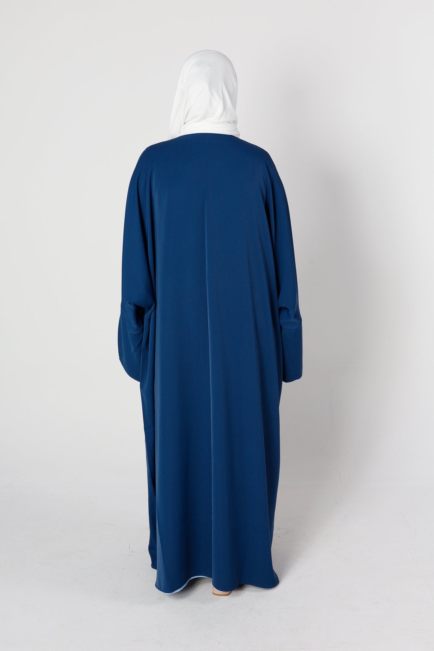 Back design of Riwaaya abaya in midnight blue with flowing modest style – Qalbi