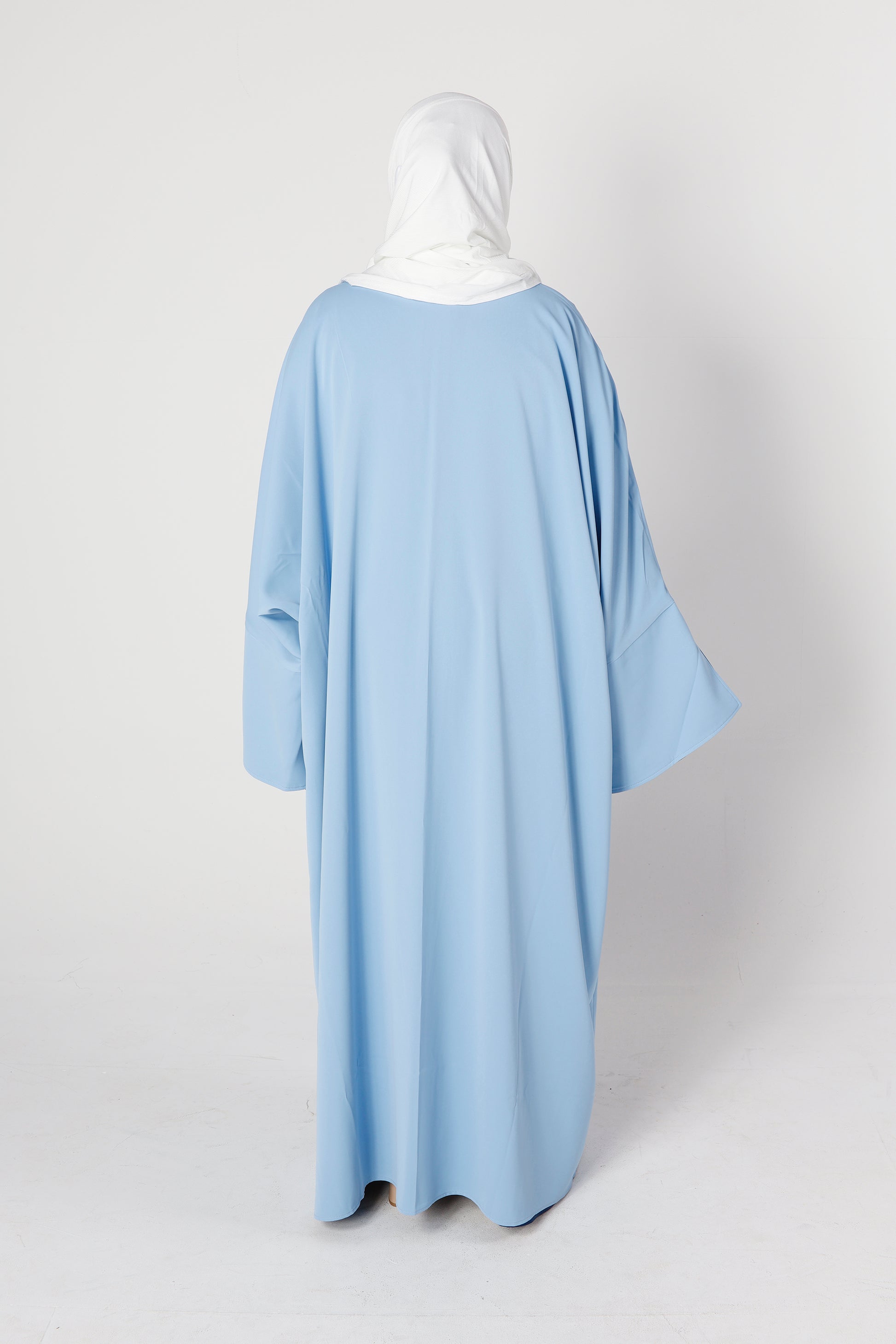 Back design of Riwaaya abaya in blue haze with flowing modest style – Qalbi