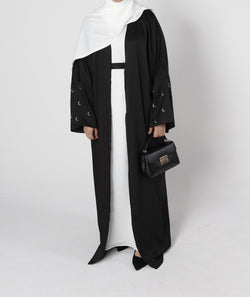 Front view of Crescent abaya in black with moon embroidery on sleeves – Qalbi modest fashion