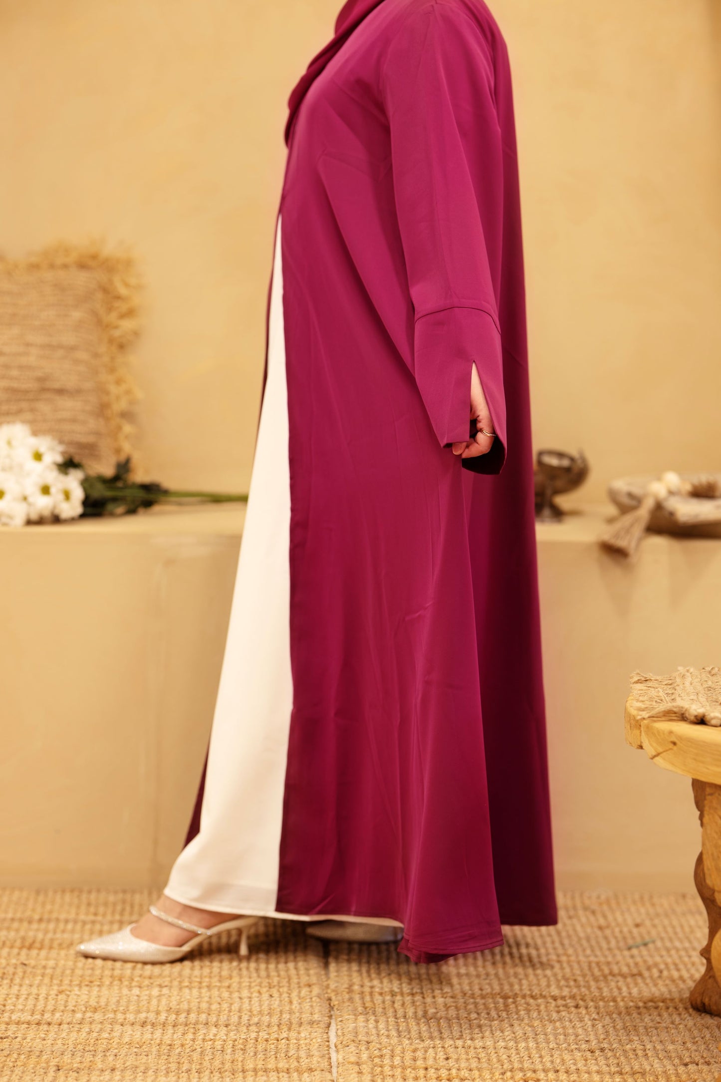 Side profile of burgundy classic abaya showing flowing Nida fabric and white inner dress — Classic Abaya Burgundy Bliss.