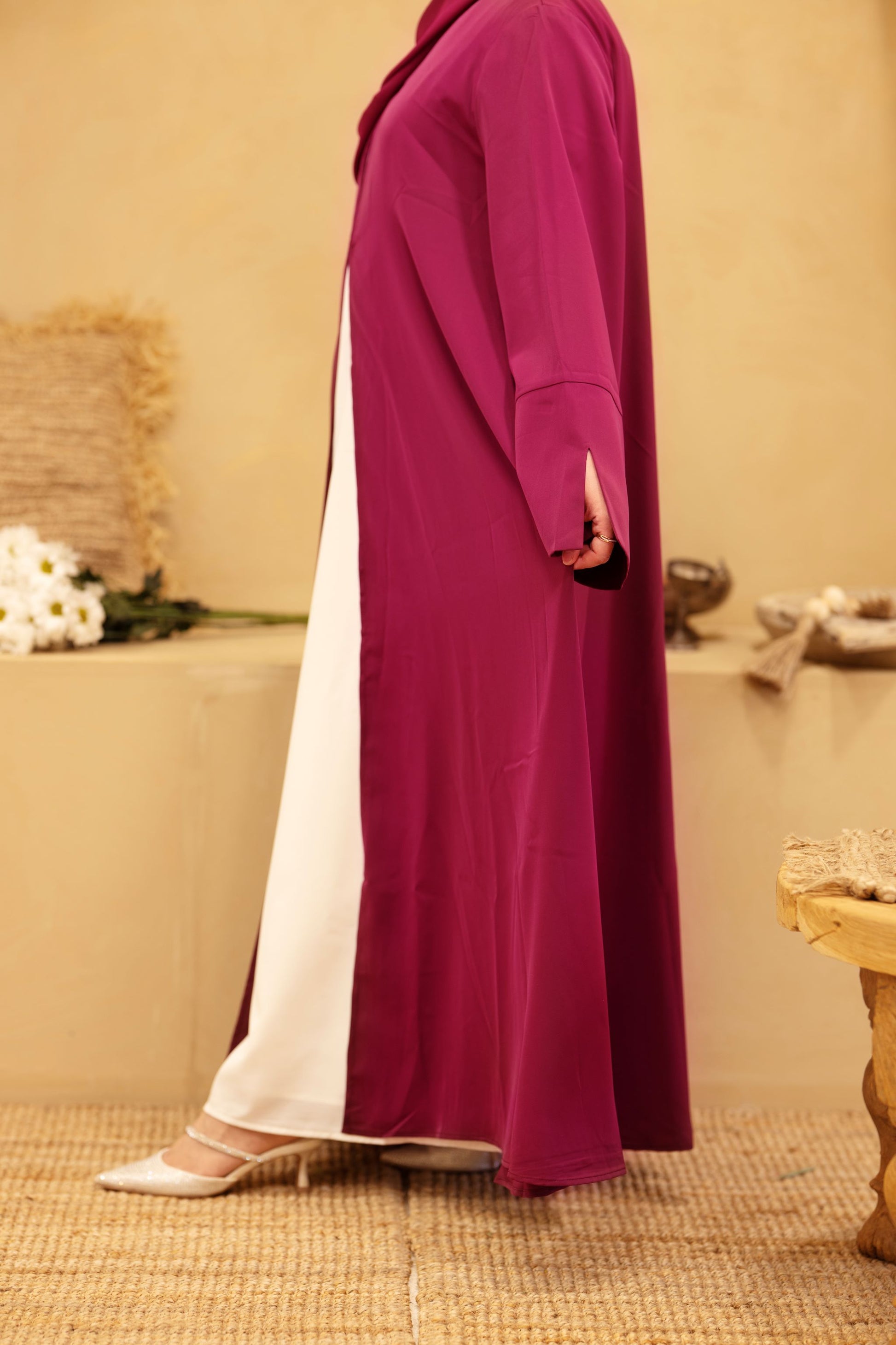 Side profile of burgundy classic abaya showing flowing Nida fabric and white inner dress — Classic Abaya Burgundy Bliss.