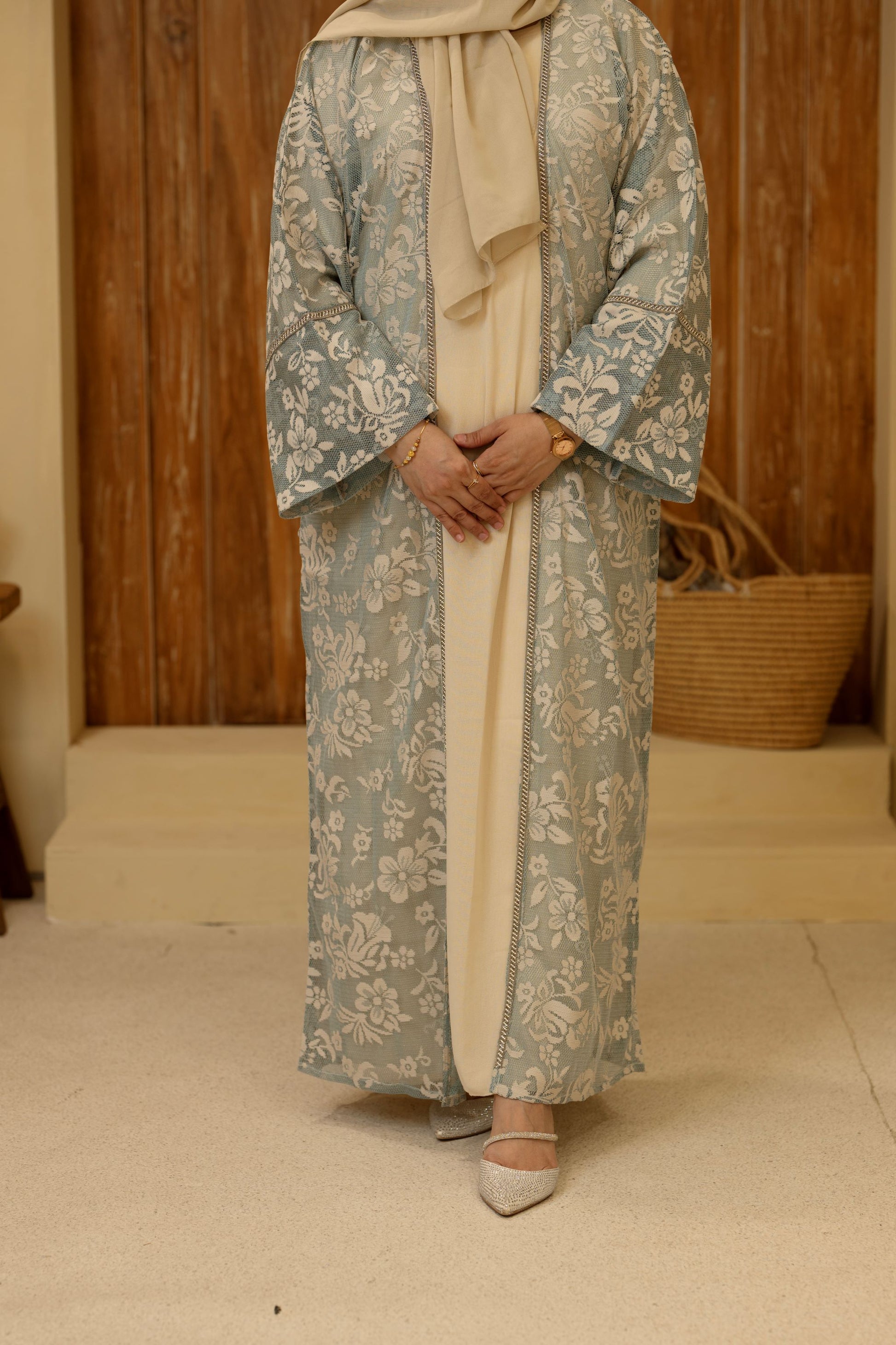 Close-up of floral embroidery on elegant emerald outfit