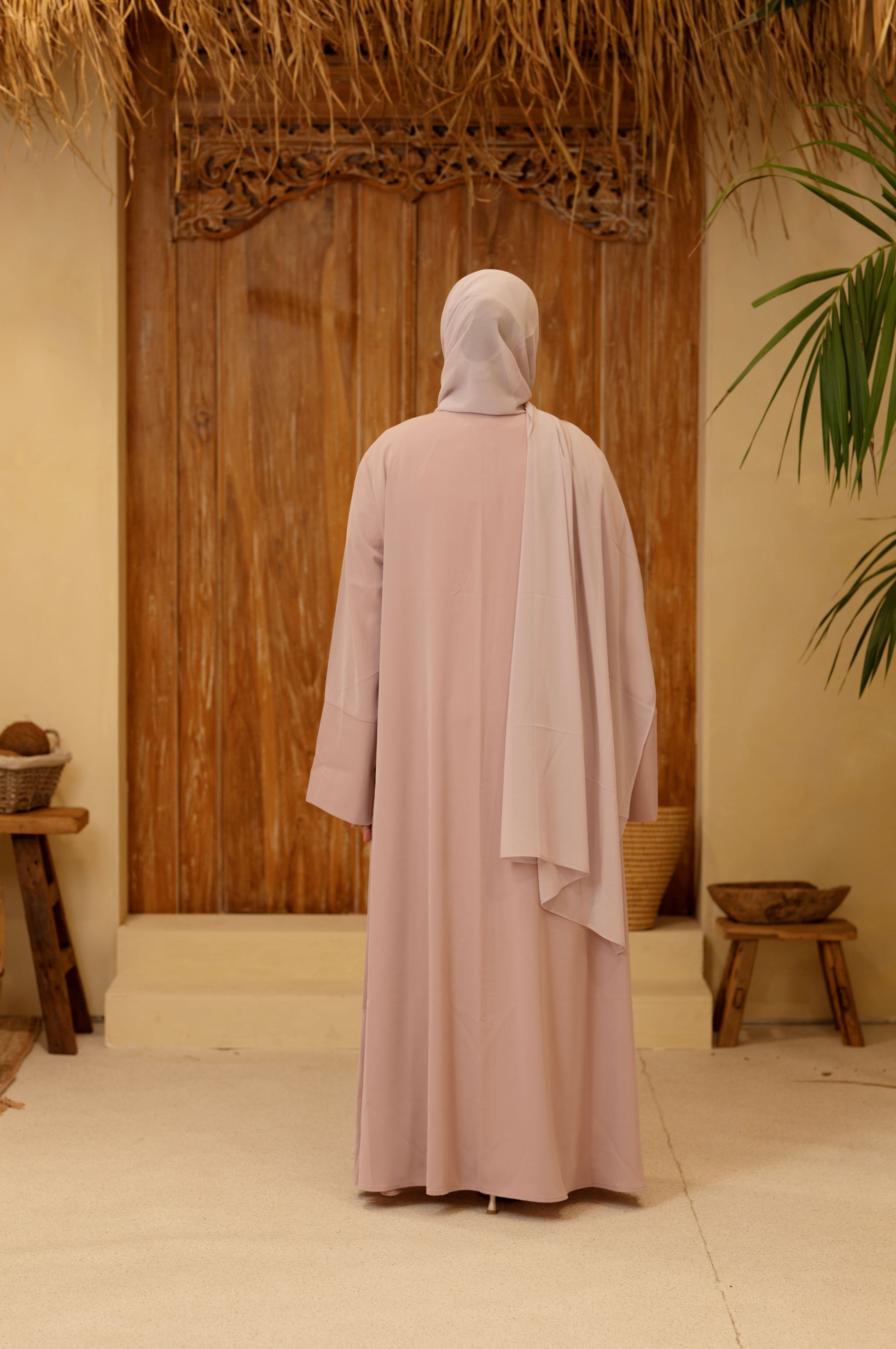 Back view of the rose mist Qalbi Classic Abaya, displaying the smooth fall and lightweight Nida fabric.
