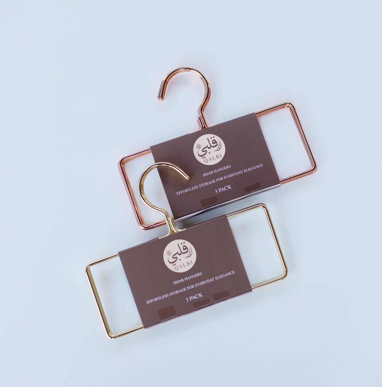 Pair of gold metal hangers arranged neatly for organised wardrobe storage