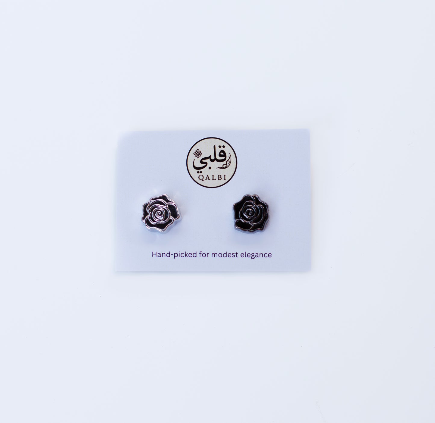 Black rose Chrome Hijab Magnets, on a white card with 'Qalbi' branding on a light gray background